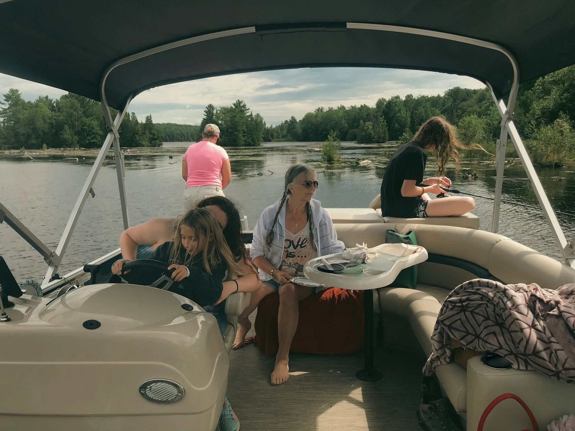 pontoon boat on lake with people